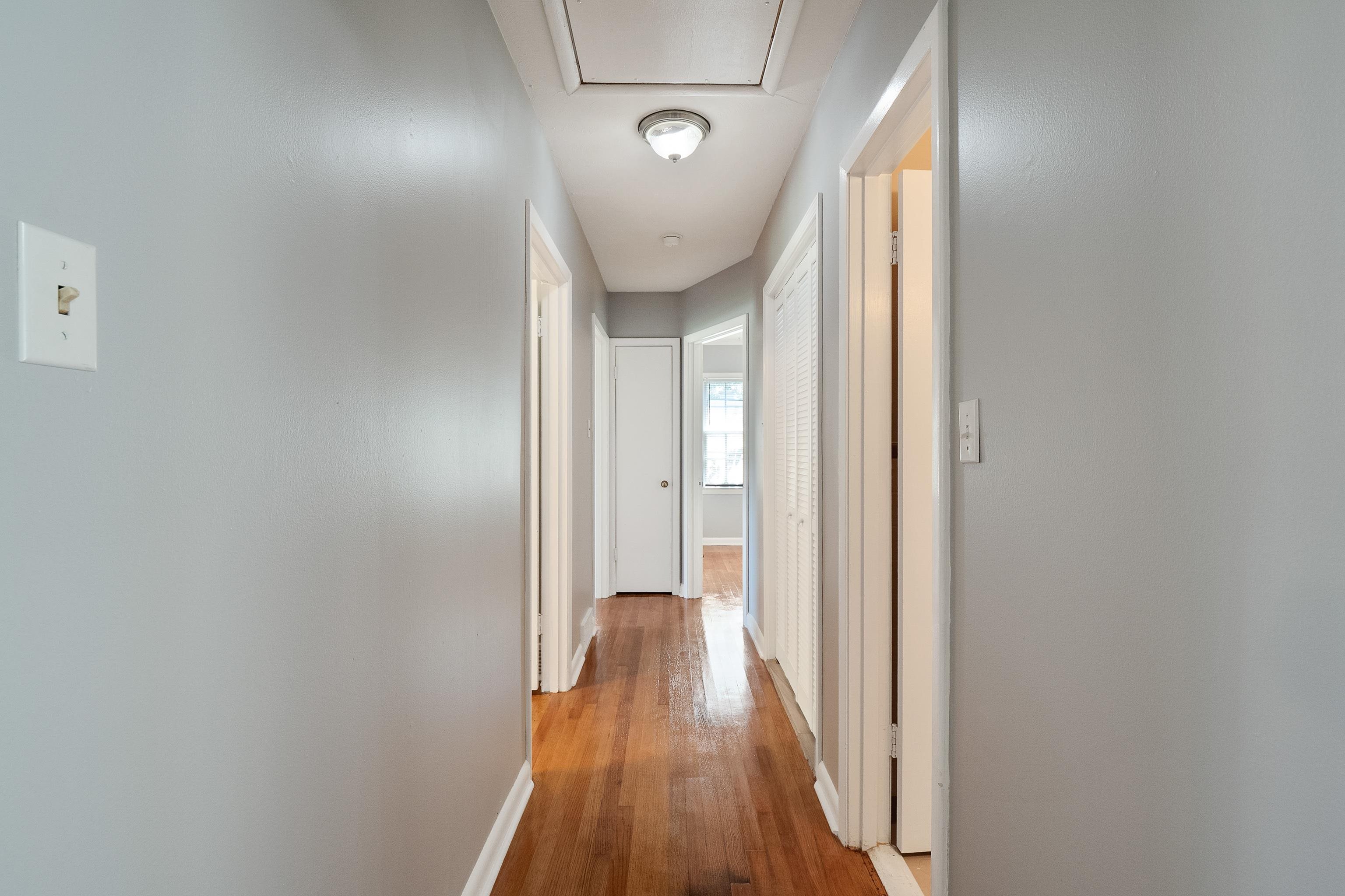 1551 Delmont Road Memphis, TN 38117 - Photo 13 of 25 a view of a hallway with wooden floor and staircase