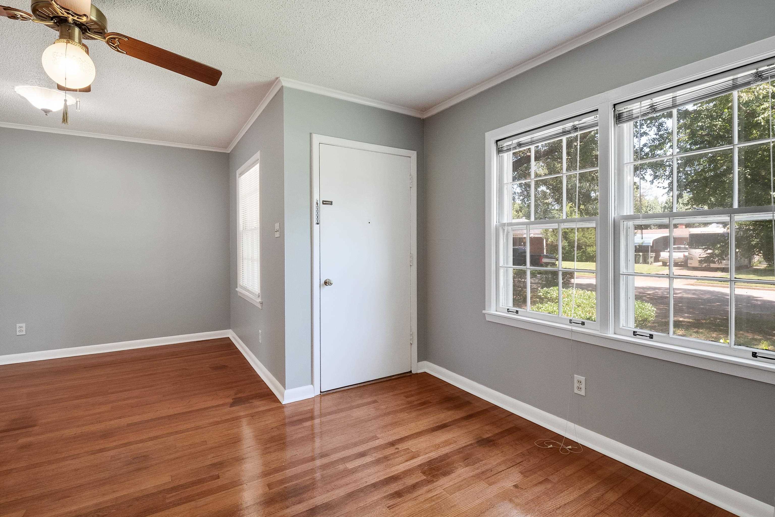 1551 Delmont Road Memphis, TN 38117 - Photo 2 of 25 a view of empty room with wooden floor and fan