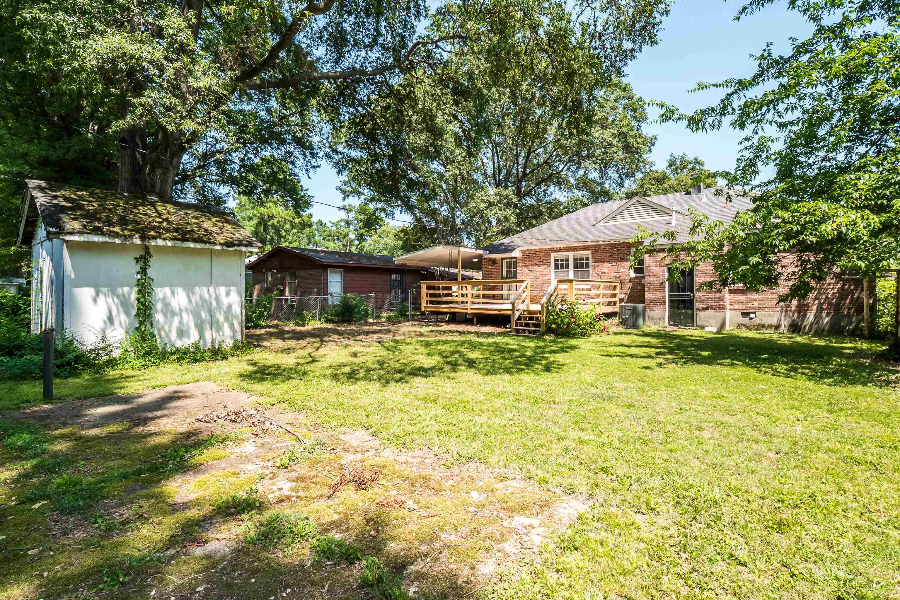 1551 Delmont Road Memphis, TN 38117 - Photo 24 of 25 a front view of a house with a yard garage and outdoor seating