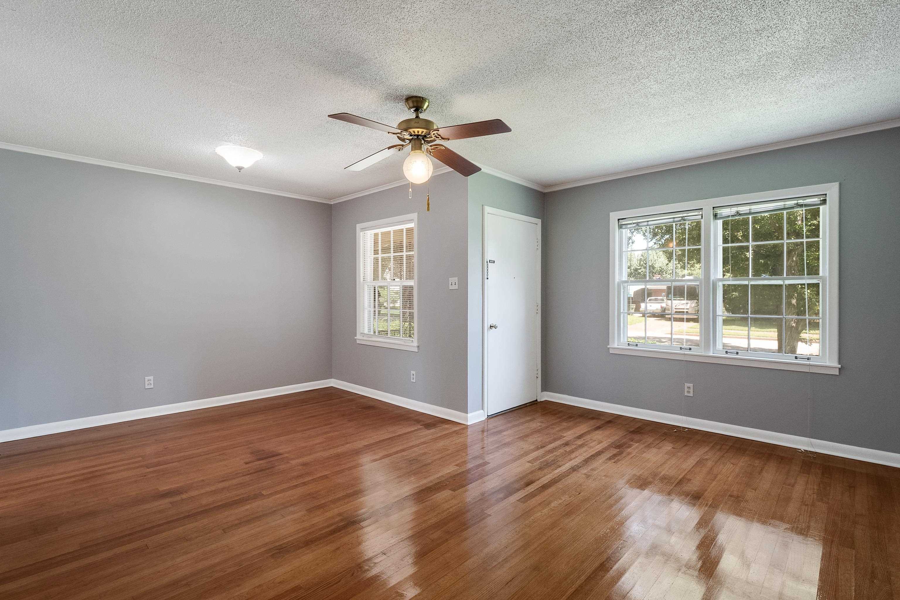 1551 Delmont Road Memphis, TN 38117 - Photo 4 of 25 a view of an empty room with chandelier fan and windows