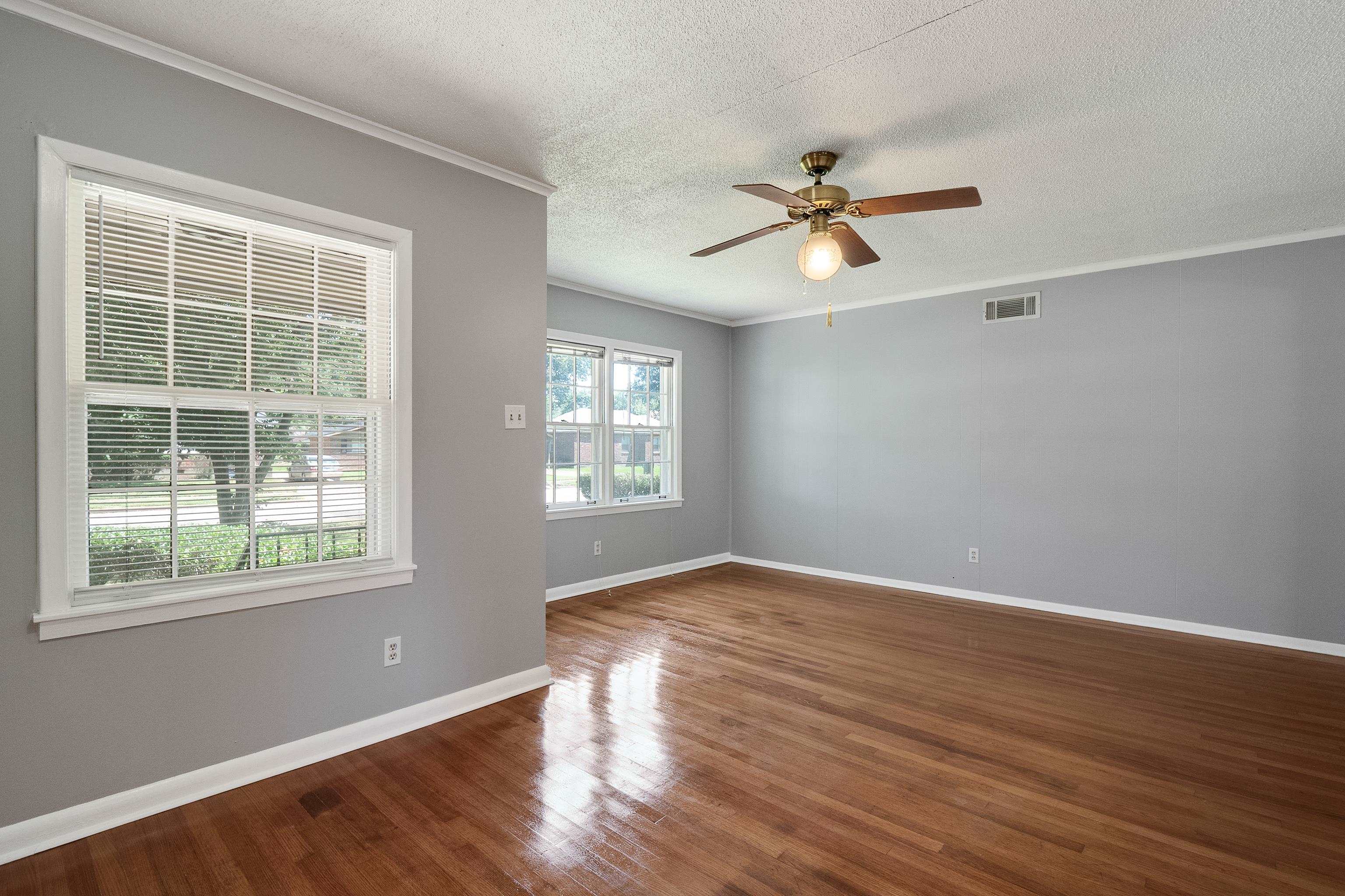 1551 Delmont Road Memphis, TN 38117 - Photo 5 of 25 a view of empty room with wooden floor and fan