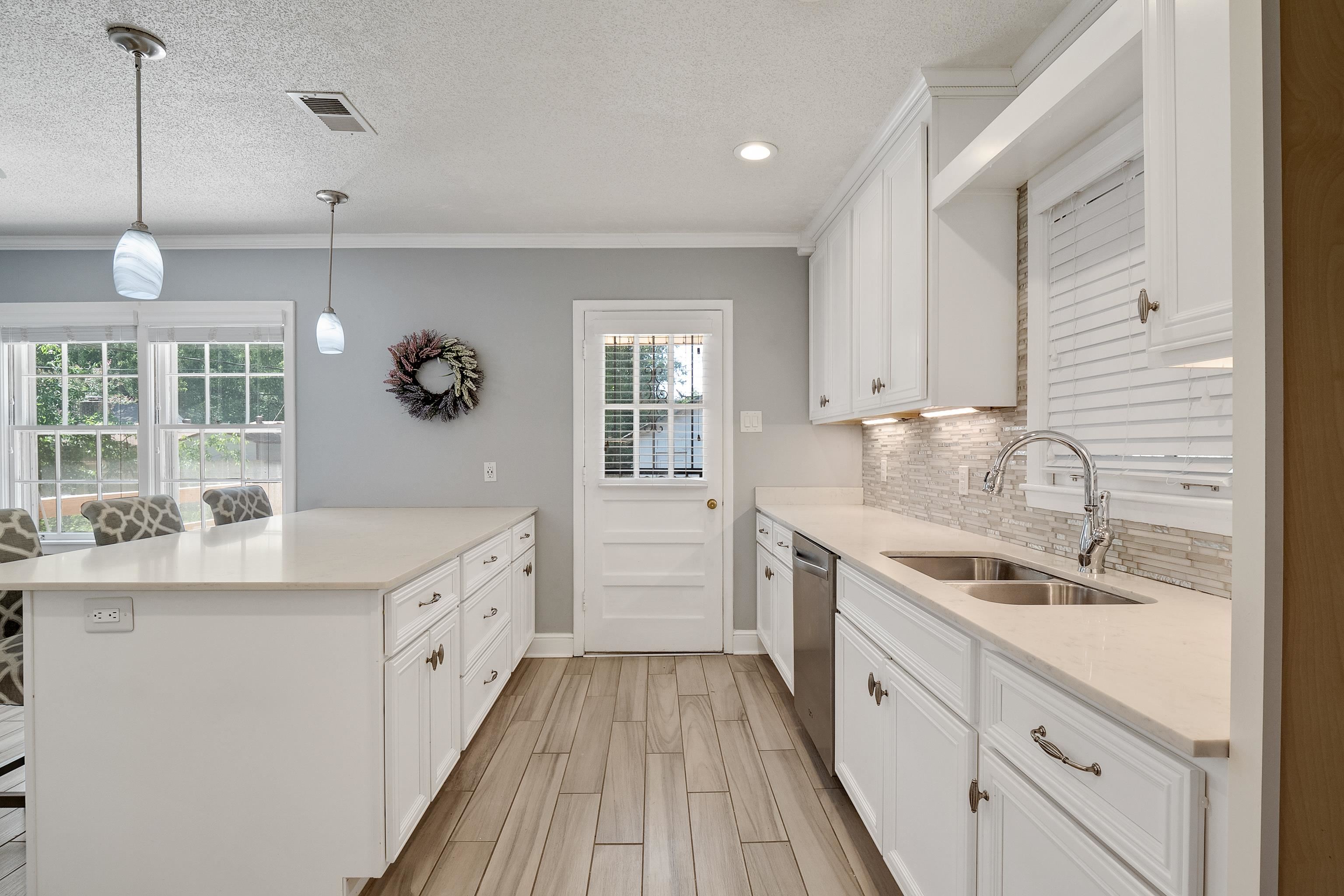 1551 Delmont Road Memphis, TN 38117 - Photo 6 of 25 a kitchen with a sink stove and cabinets