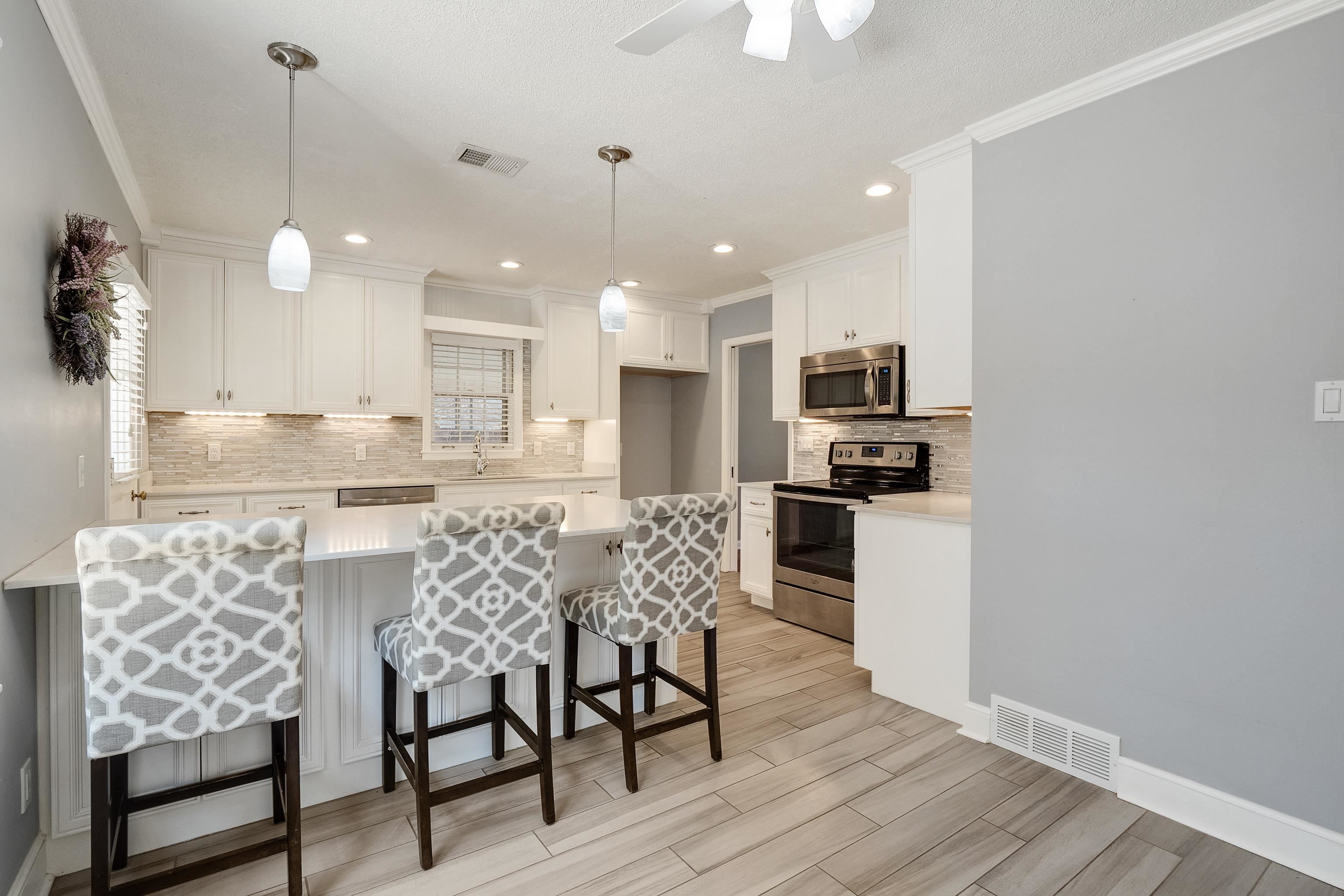 1551 Delmont Road Memphis, TN 38117 - Photo 8 of 25 a kitchen with stainless steel appliances kitchen island granite countertop a dining table chairs and sink
