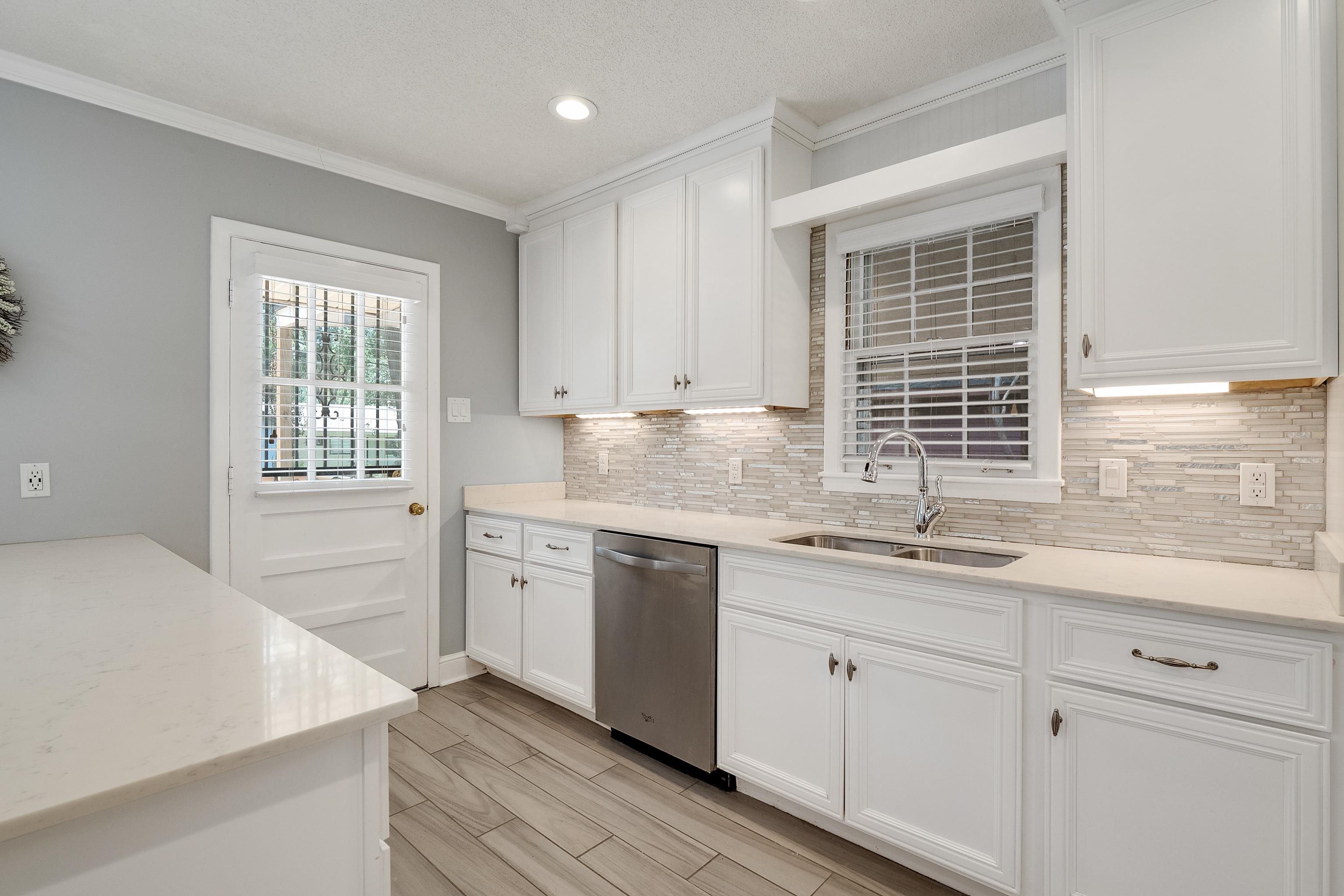1551 Delmont Road Memphis, TN 38117 - Photo 9 of 25 a kitchen with granite countertop white cabinets and white appliances