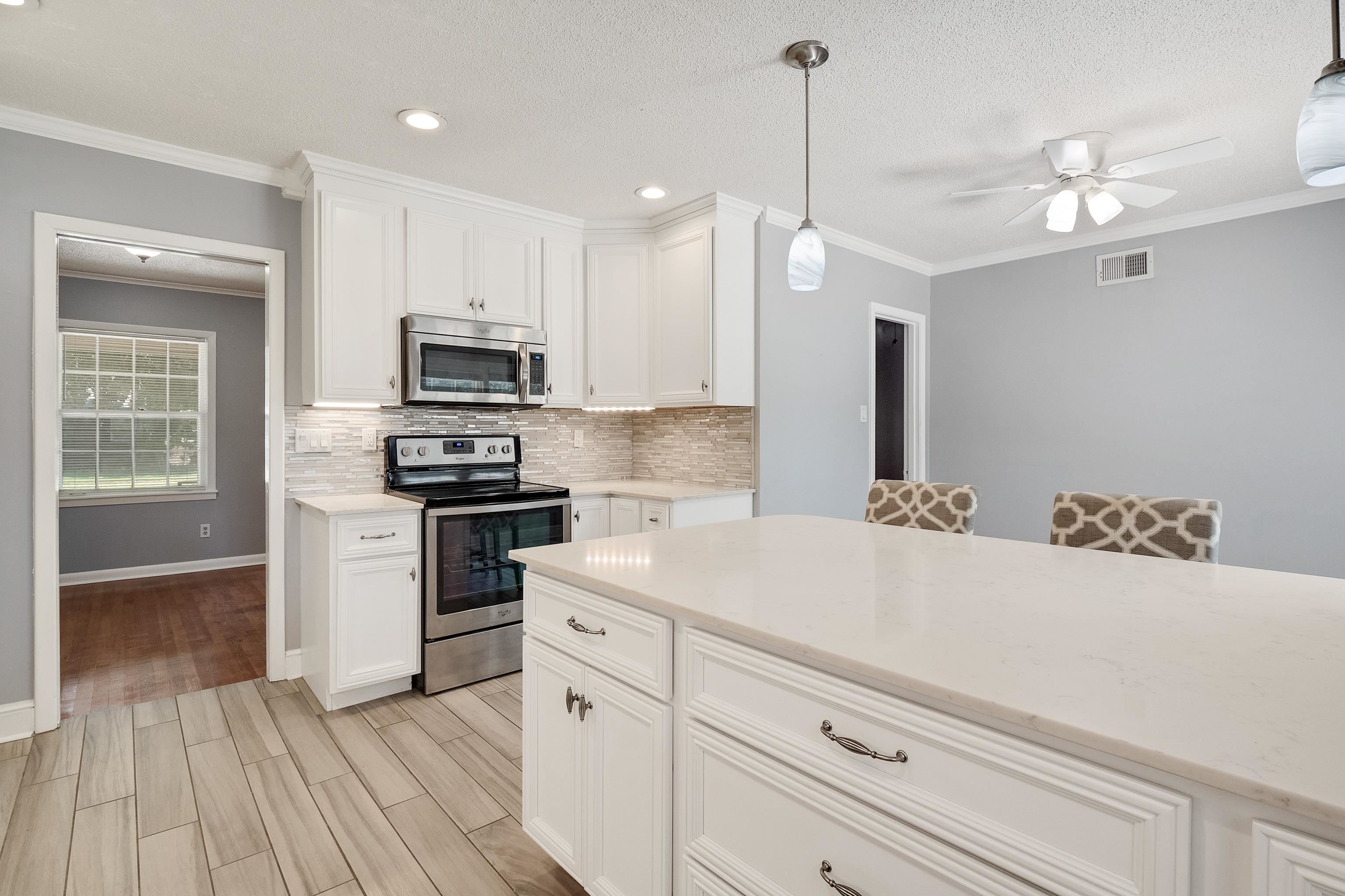 1551 Delmont Road Memphis, TN 38117 - Photo 10 of 25 a kitchen with granite countertop a sink stainless steel appliances and cabinets