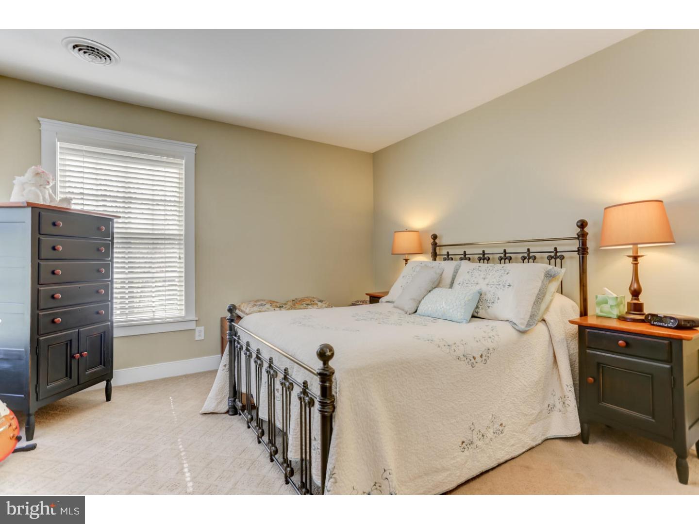 1710 Hickory Hill Road Chadds Ford, PA 19317 - Photo 17 of 25 a bedroom with a bed and a flat tv screen on dresser