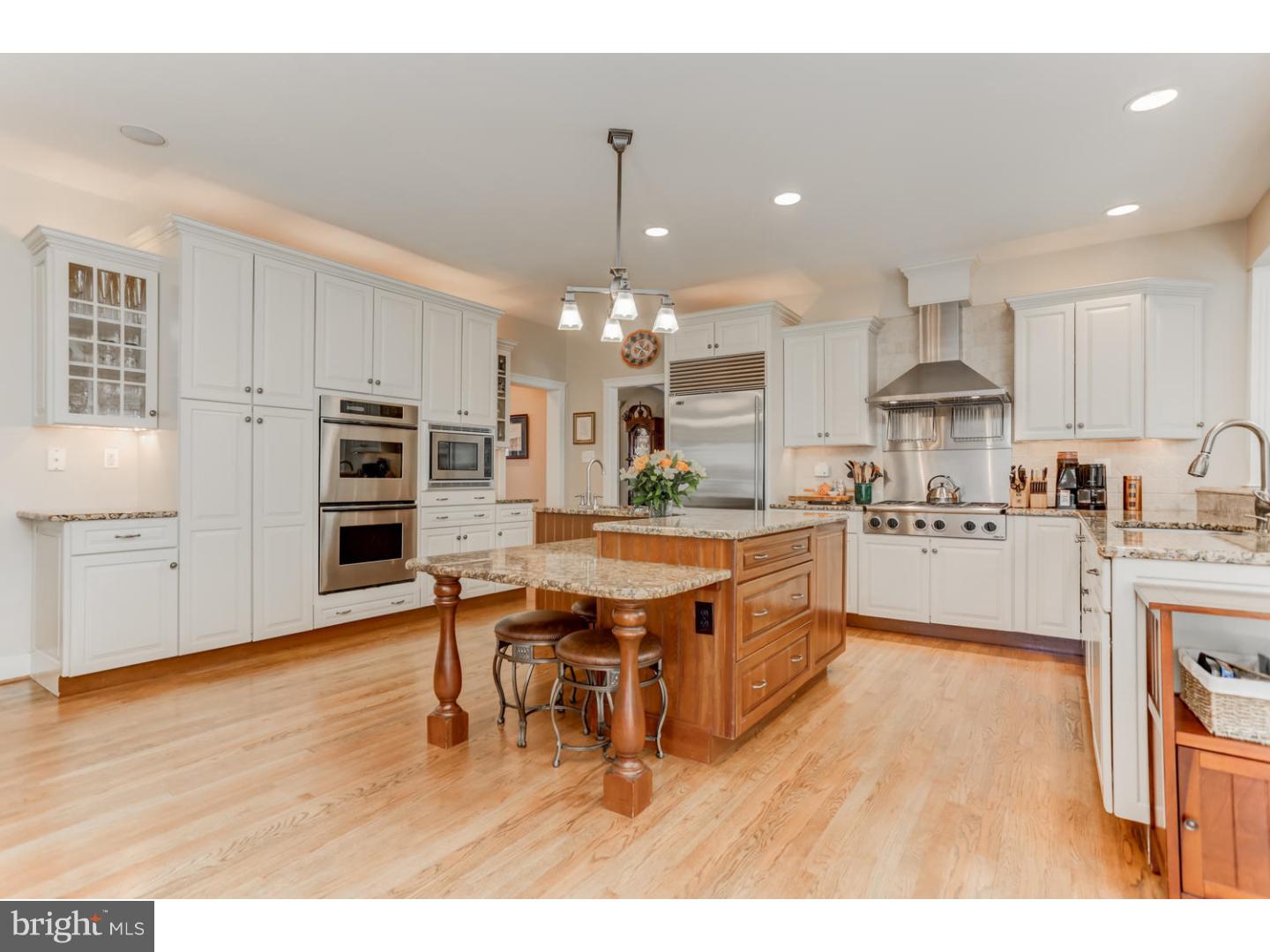 1710 Hickory Hill Road Chadds Ford, PA 19317 - Photo 7 of 25 a kitchen with stainless steel appliances kitchen island granite countertop a table chairs sink and cabinets