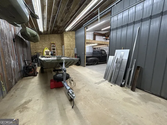 a view of a forest with trees in the background