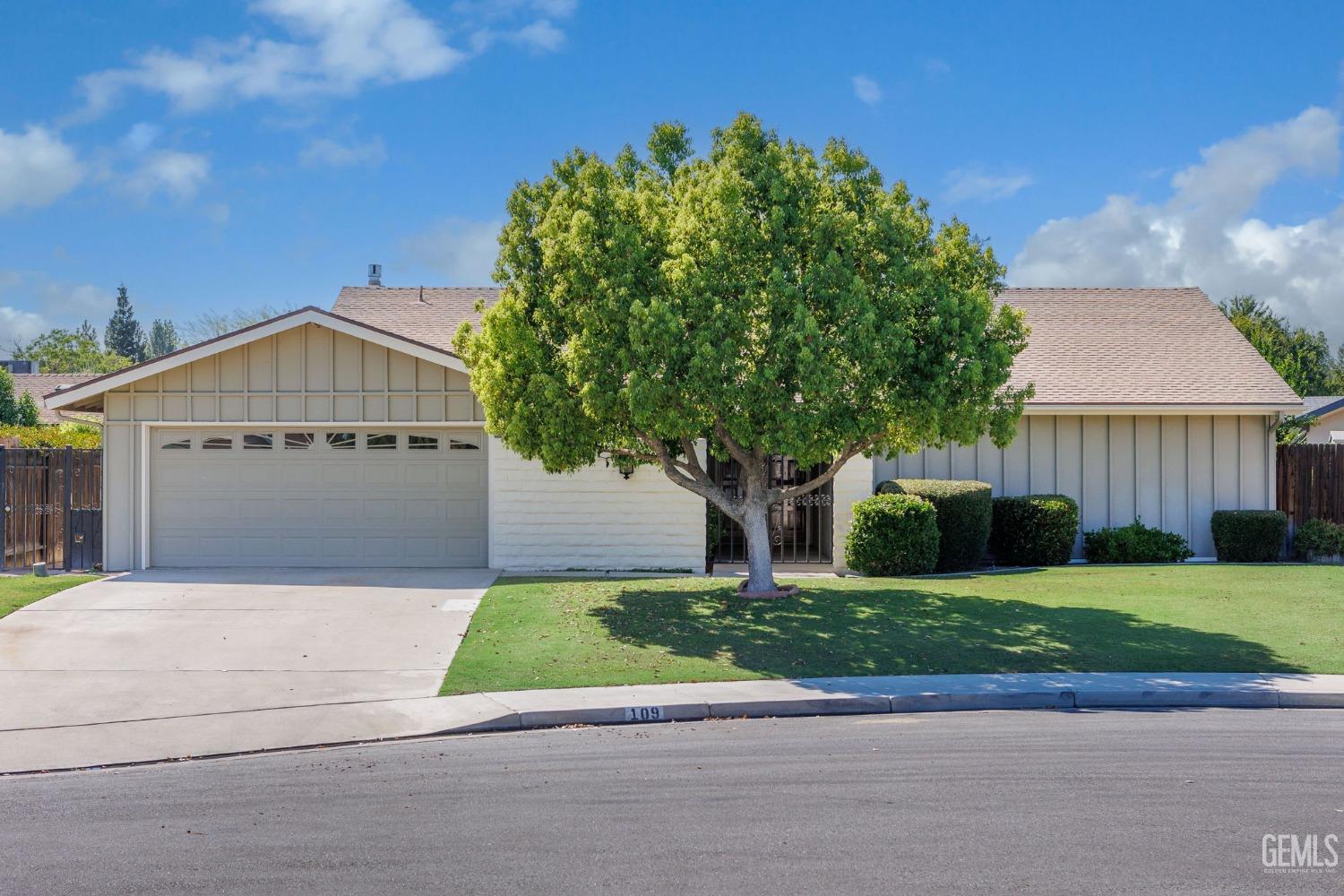 Undisclosed Address Bakersfield, CA 93309 - Photo 1 of 43 a front view of a house with a yard and garage