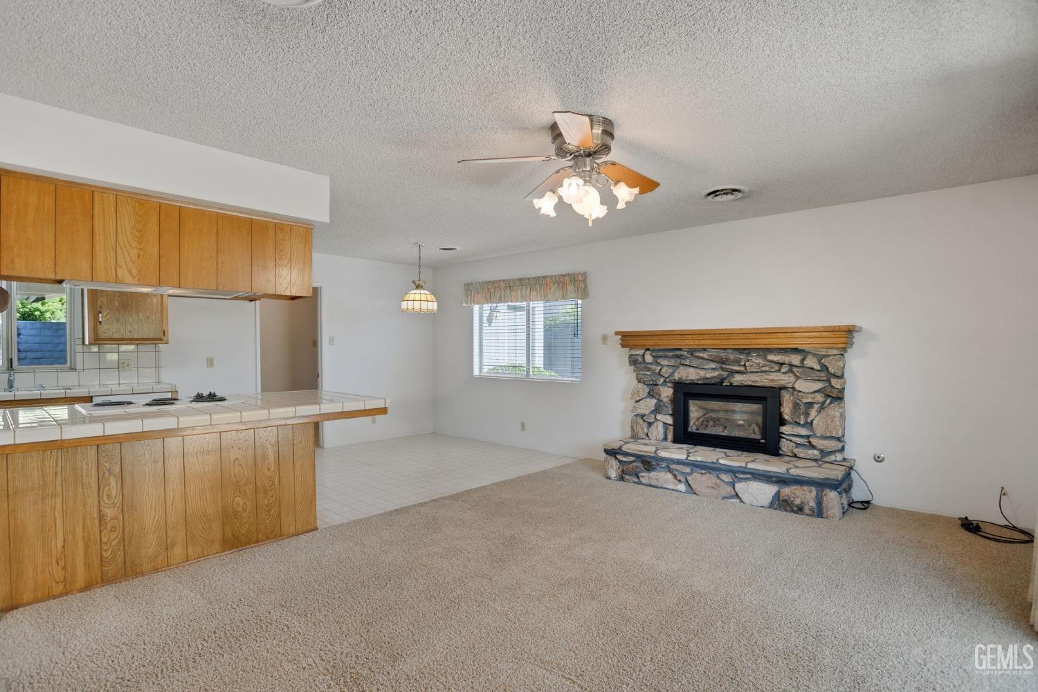 Undisclosed Address Bakersfield, CA 93309 - Photo 12 of 43 a living room with furniture and a fireplace