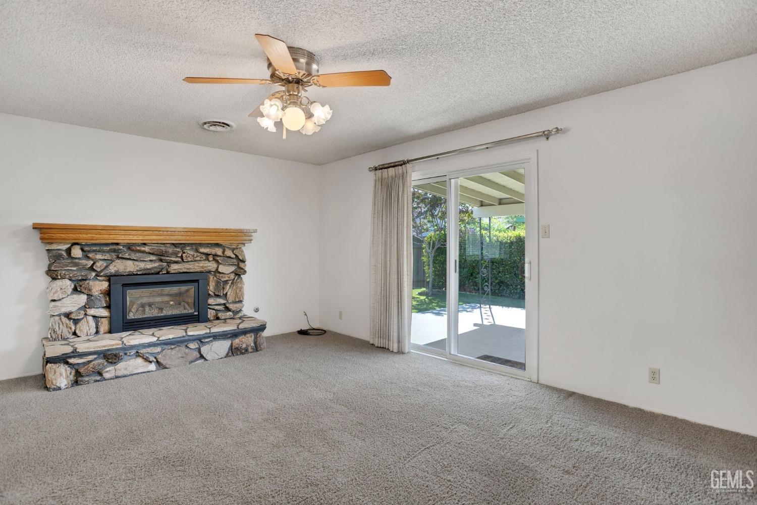 Undisclosed Address Bakersfield, CA 93309 - Photo 13 of 43 a living room with furniture and a fireplace