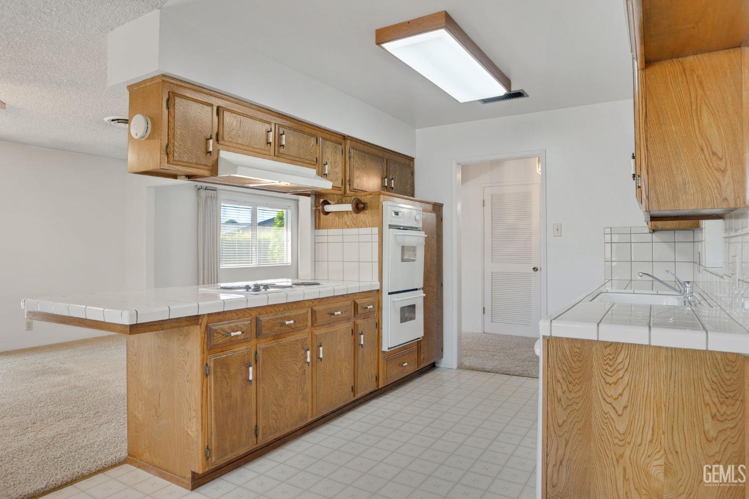 Undisclosed Address Bakersfield, CA 93309 - Photo 18 of 43 a kitchen with stainless steel appliances granite countertop a sink and cabinets with wooden floor