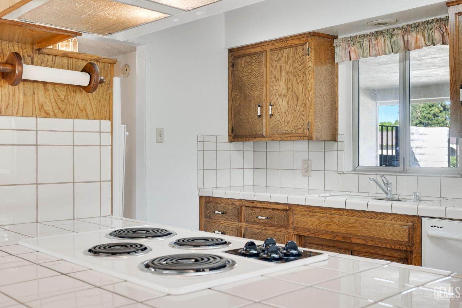 Undisclosed Address Bakersfield, CA 93309 - Photo 20 of 43 a kitchen with a sink stove and cabinets