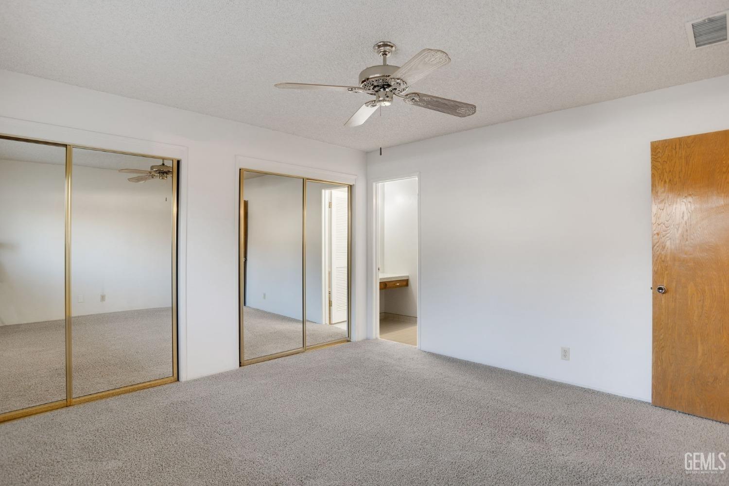 Undisclosed Address Bakersfield, CA 93309 - Photo 28 of 43 a view of a room with a ceiling fan and closet area