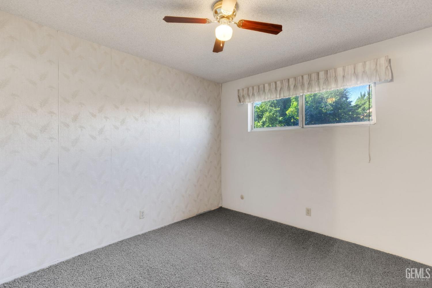 Undisclosed Address Bakersfield, CA 93309 - Photo 32 of 43 an empty room with wooden floor fan and windows