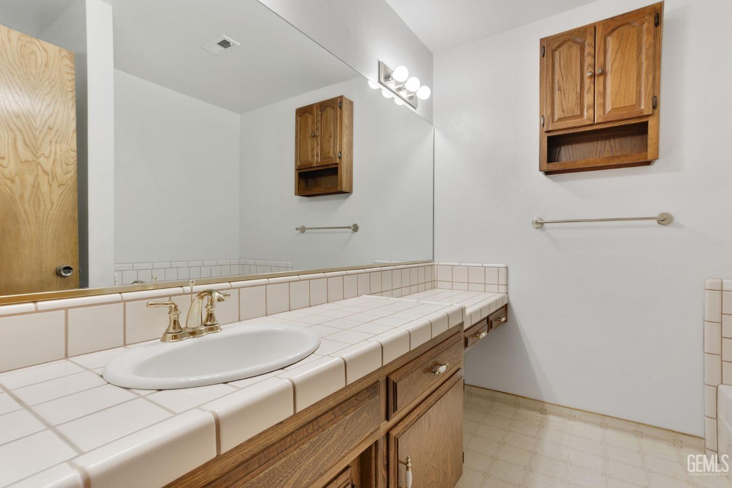 Undisclosed Address Bakersfield, CA 93309 - Photo 34 of 43 a bathroom with a sink and a mirror