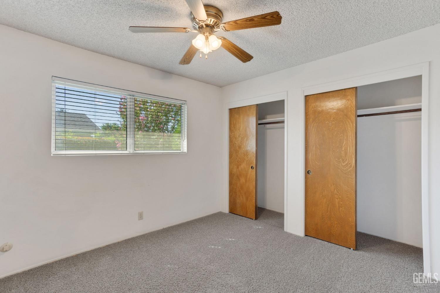 Undisclosed Address Bakersfield, CA 93309 - Photo 36 of 43 a view of an empty room with a ceiling fan and a window