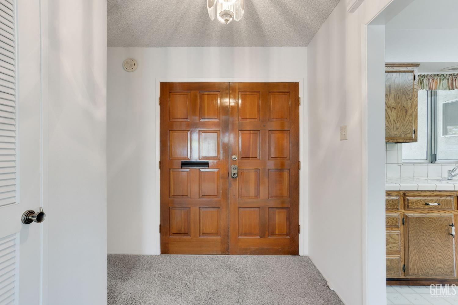 Undisclosed Address Bakersfield, CA 93309 - Photo 7 of 43 a view of a hallway with wooden floor and a cabinet