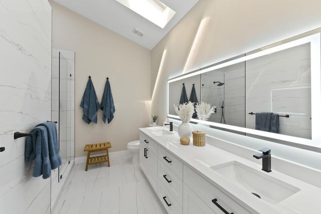 a bathroom with a double vanity sink a mirror and