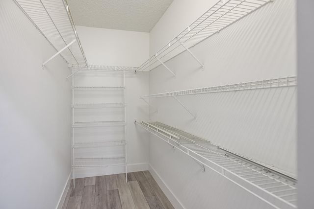 a view of walk in closet with empty racks