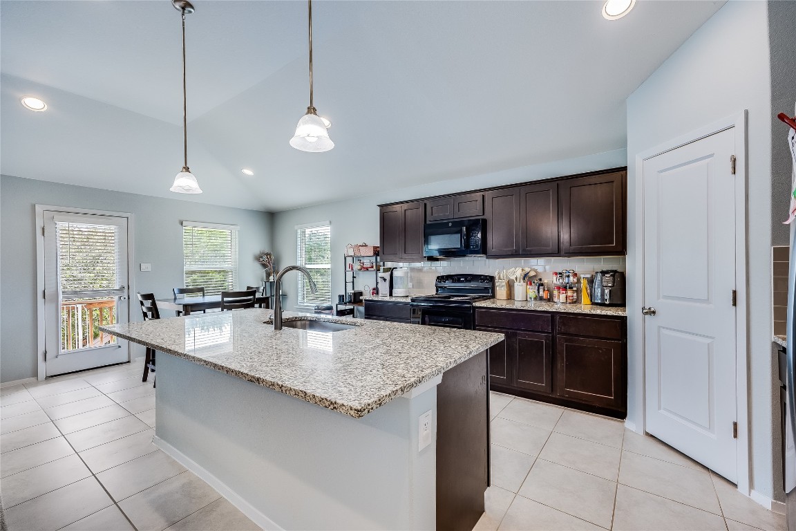 21302 Santa Rosa Avenue Lago Vista, TX 78645 - Photo 2 of 26 a large kitchen with granite countertop lots of counter top space