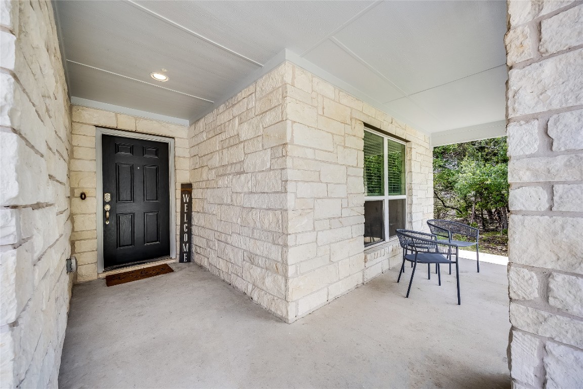 21302 Santa Rosa Avenue Lago Vista, TX 78645 - Photo 4 of 26 a view of a patio with table and chairs and potted plants