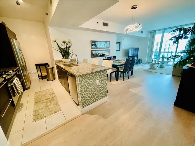 a living room with furniture a flat screen tv and a large window
