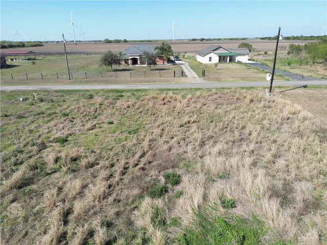 a view of a yard with wooden fence