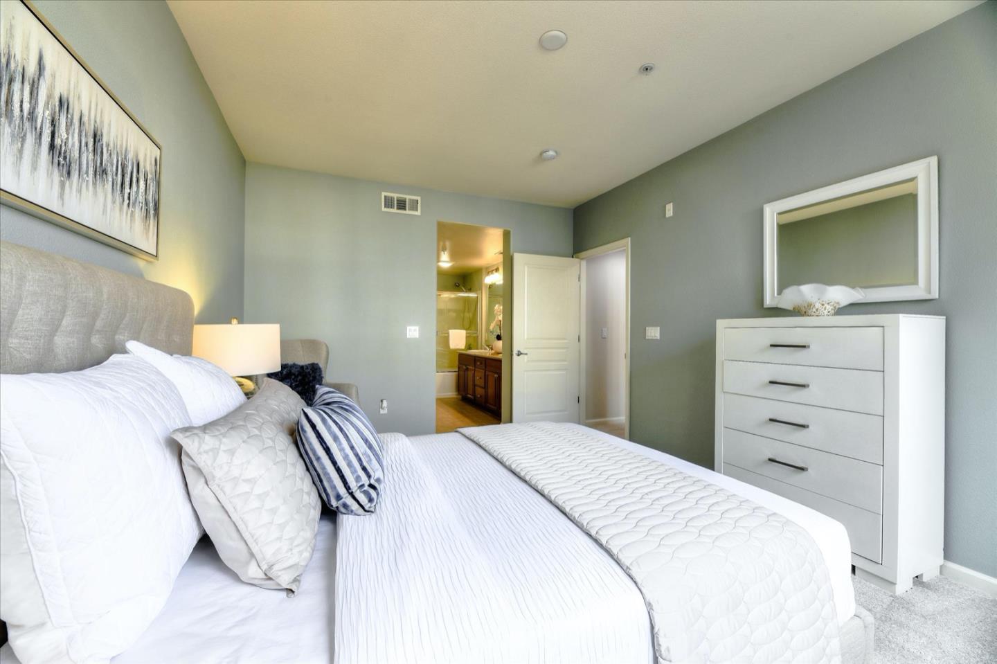 1883 Agnew Road, Unit 357 Santa Clara, CA 95054 - Photo 13 of 27 a bedroom with a bed and a mirror