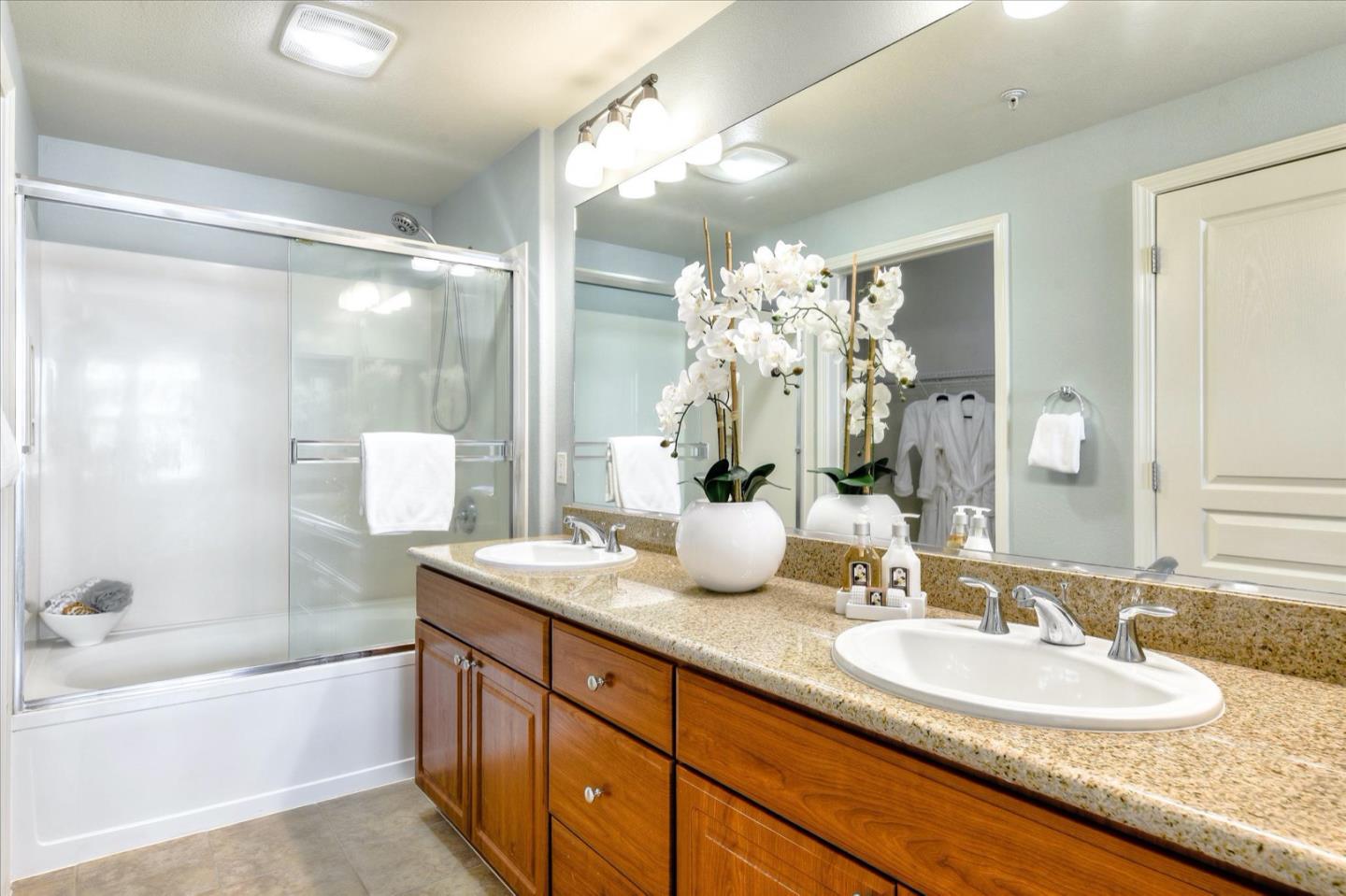 1883 Agnew Road, Unit 357 Santa Clara, CA 95054 - Photo 14 of 27 a bathroom with a granite countertop sink mirror and a bath tub