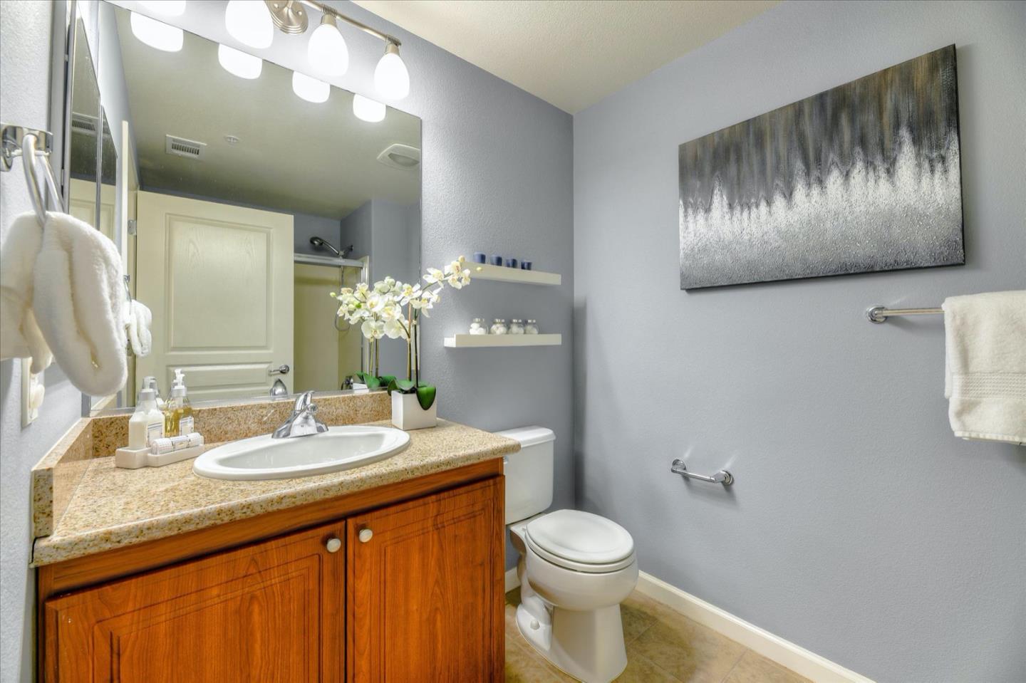 1883 Agnew Road, Unit 357 Santa Clara, CA 95054 - Photo 20 of 27 a bathroom with a toilet sink and mirror
