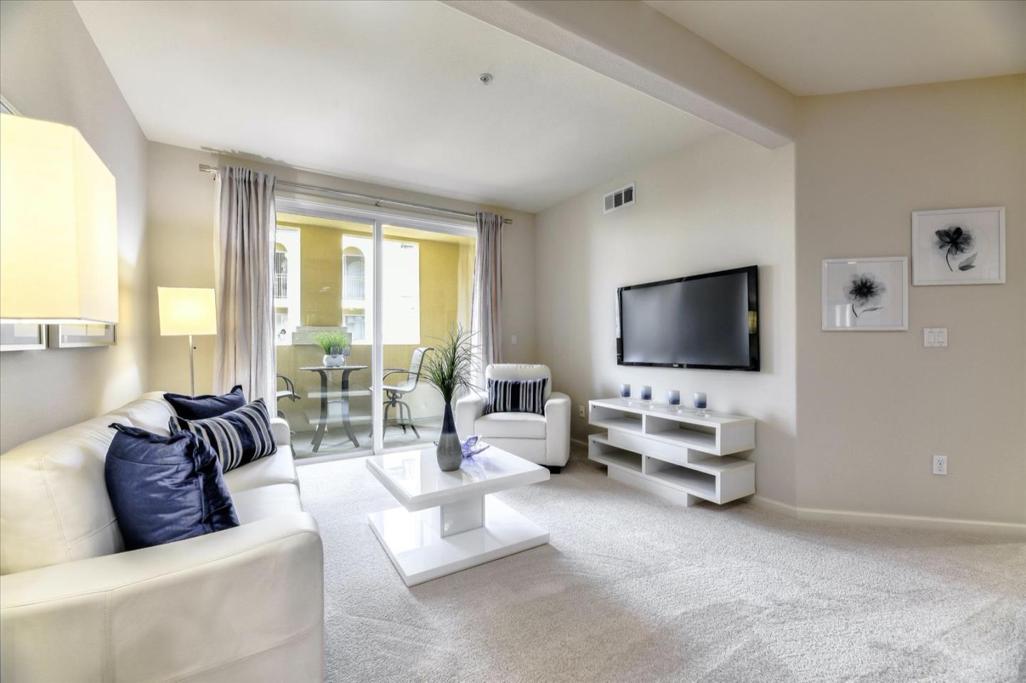 1883 Agnew Road, Unit 357 Santa Clara, CA 95054 - Photo 2 of 27 a living room with furniture and a flat screen tv