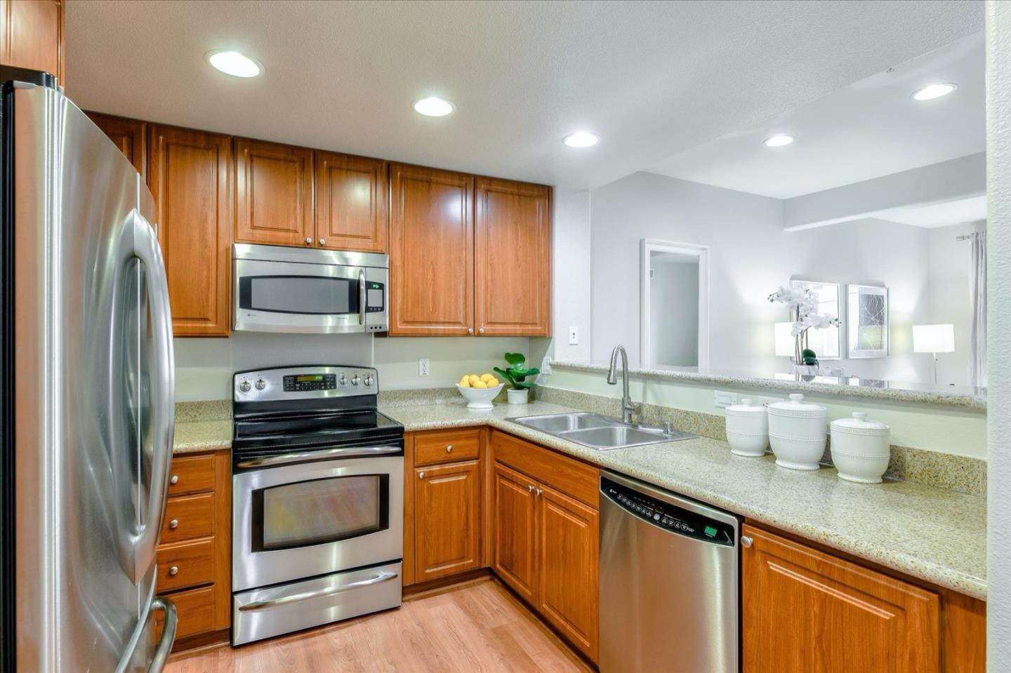 1883 Agnew Road, Unit 357 Santa Clara, CA 95054 - Photo 6 of 27 a kitchen with sink a microwave a stove and cabinets