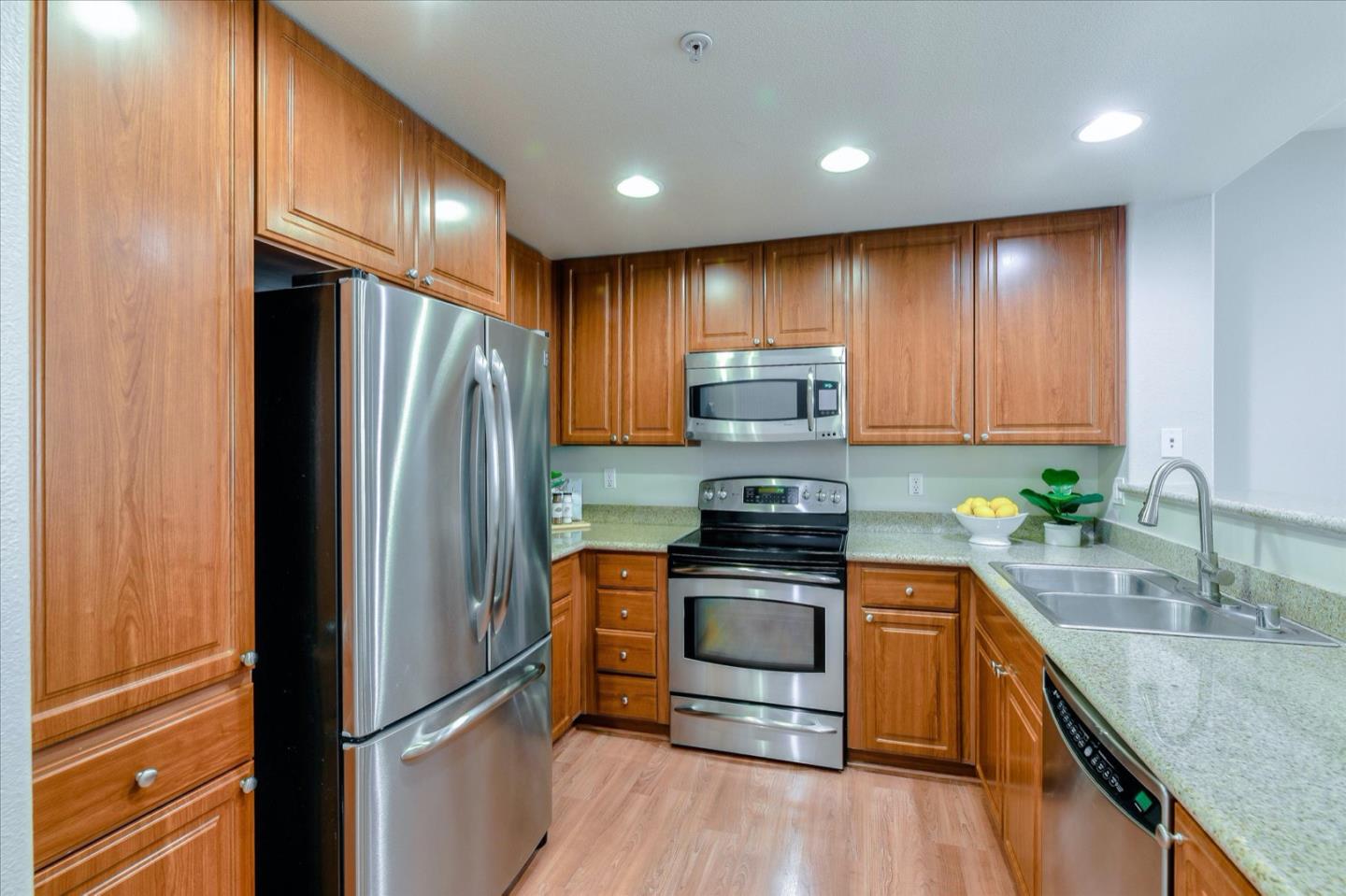 1883 Agnew Road, Unit 357 Santa Clara, CA 95054 - Photo 7 of 27 a kitchen with stainless steel appliances granite countertop a refrigerator stove and sink