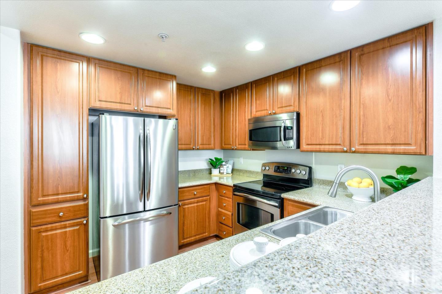 1883 Agnew Road, Unit 357 Santa Clara, CA 95054 - Photo 8 of 27 a kitchen with stainless steel appliances granite countertop a refrigerator a stove top oven a sink and dishwasher