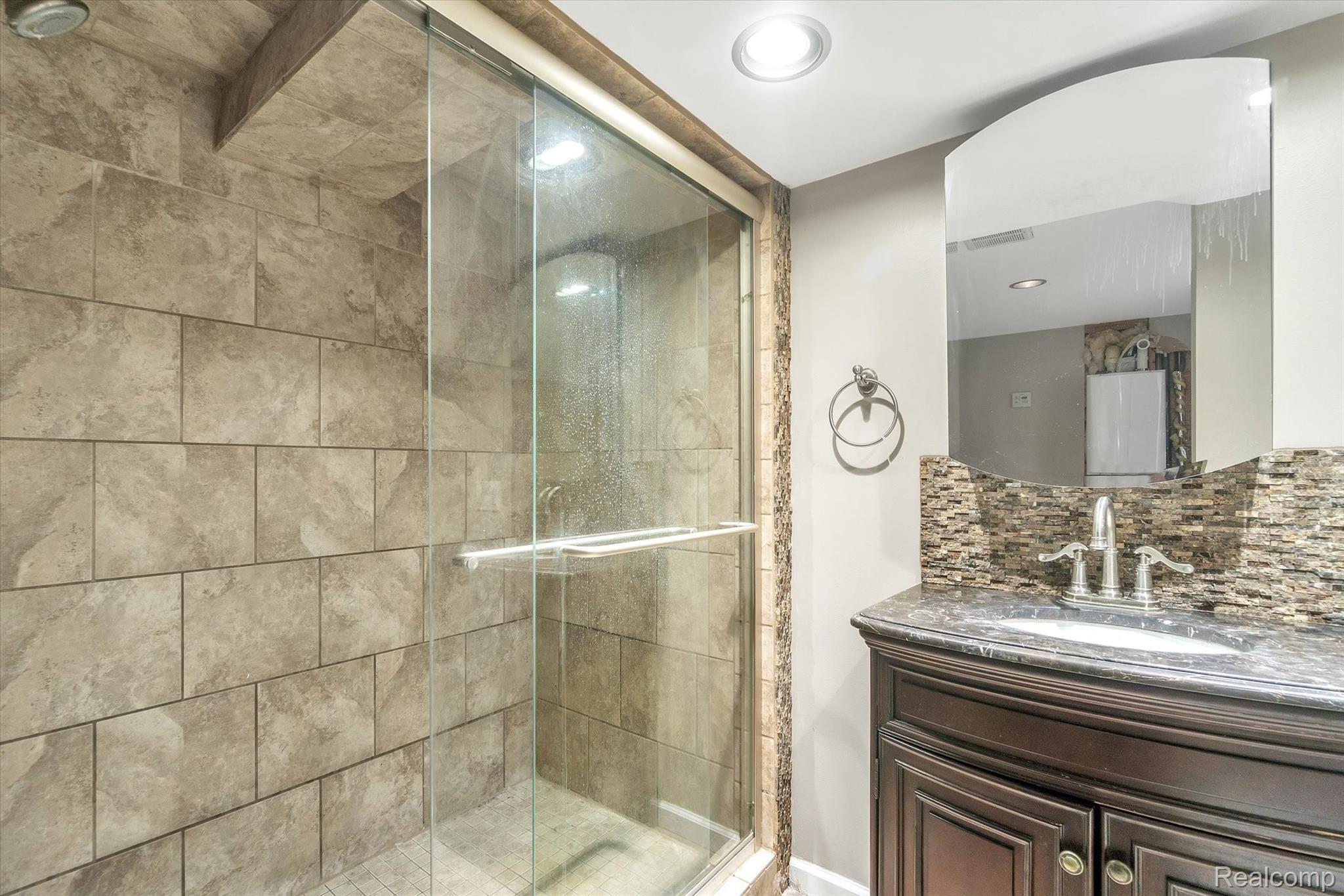 165 Harmon Road Howell, MI 48843 - Photo 23 of 39 Tile Shower And Granite Sink In Lower-Level Bath