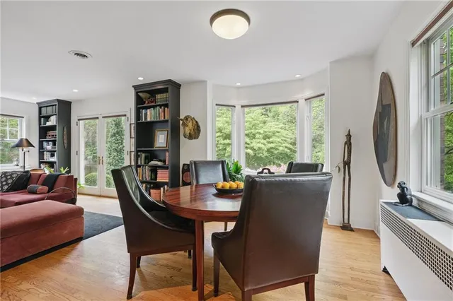 a dining room with furniture and a window