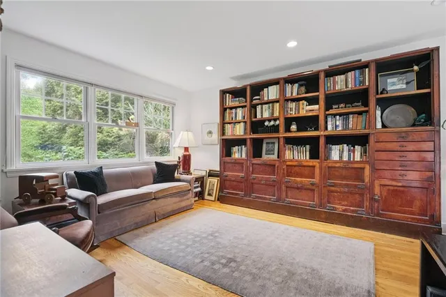 a living room with furniture cabinets and a book shelf