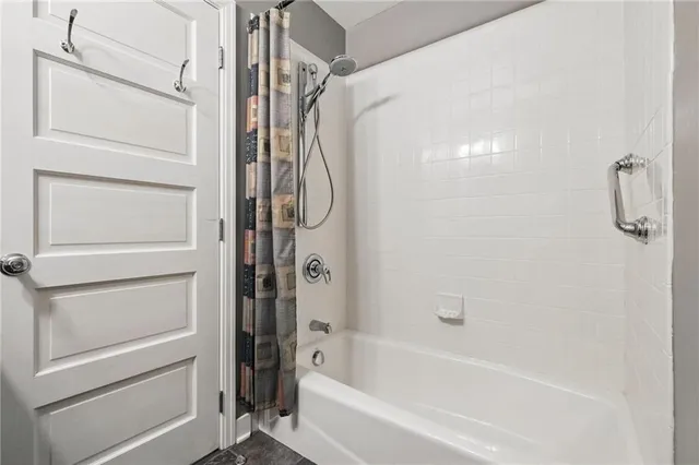 a bathroom with a bathtub and shower