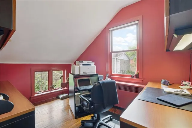 a view of a workspace with furniture and a window