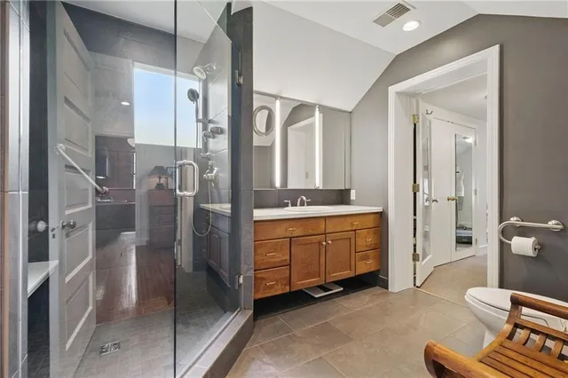 a spacious bathroom with a double vanity sink a mirror a bathtub and shower