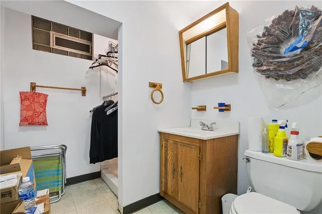 a bathroom with a sink a toilet and a shower curtain