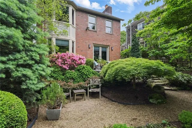 a couple of table and chairs in front of a house