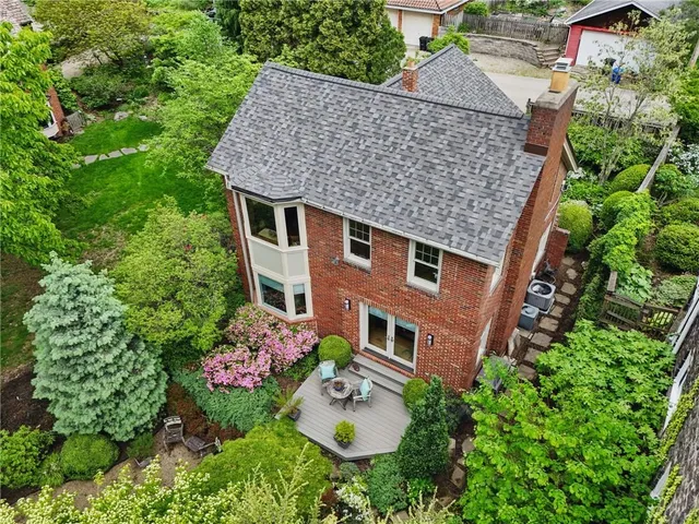 an aerial view of a house with yard table and chairs