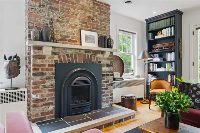a living room with fireplace furniture and a book shelf