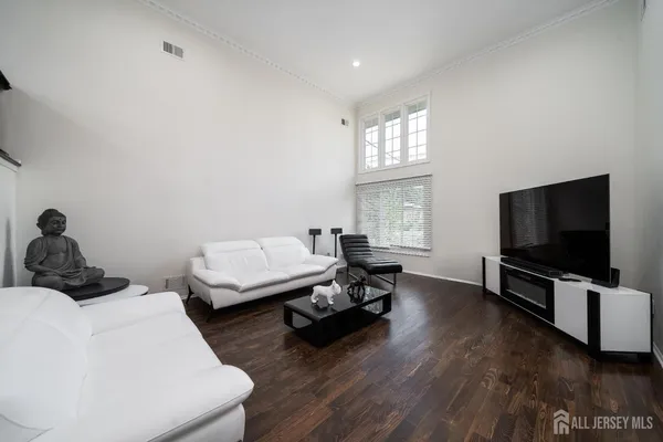 a bedroom with furniture and a flat screen tv
