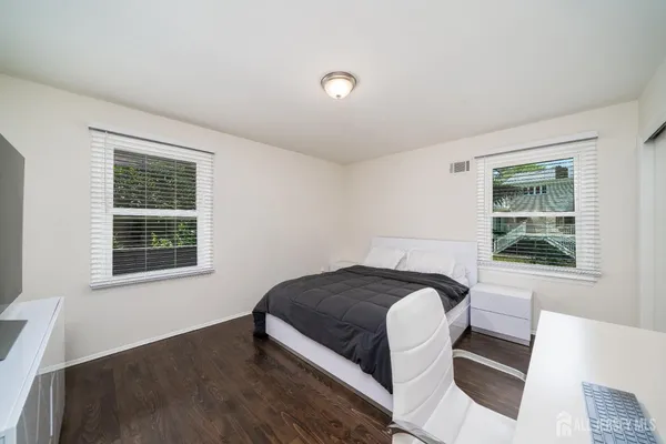 a bed sitting in a bedroom next to a window