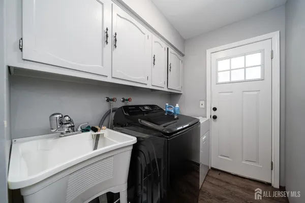 a kitchen with a sink cabinets and stainless steel appliances