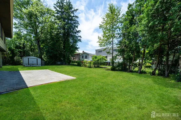 a view of yard with swimming pool and green space