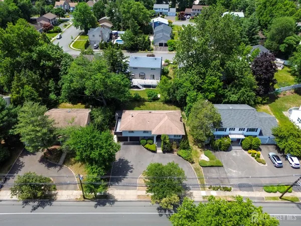 an aerial view of a house with yard and outdoor seating